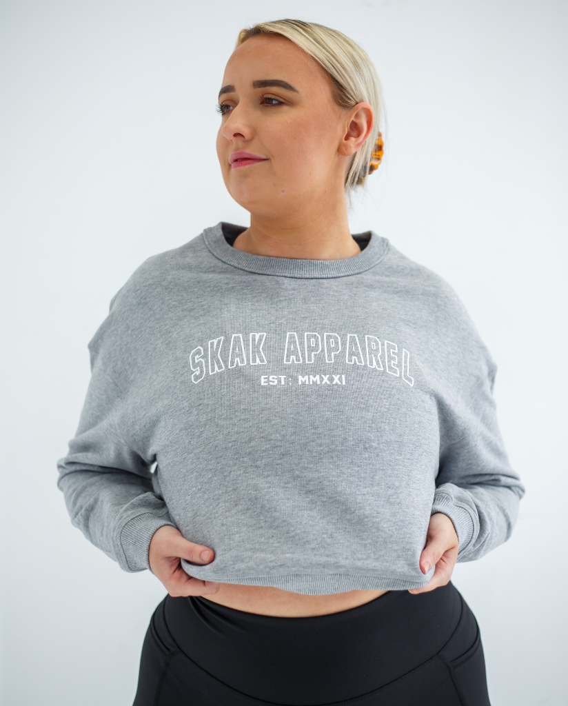 Stay cozy and stylish with our Ladies Crop Crew Neck in Grey, perfect for any casual occasion